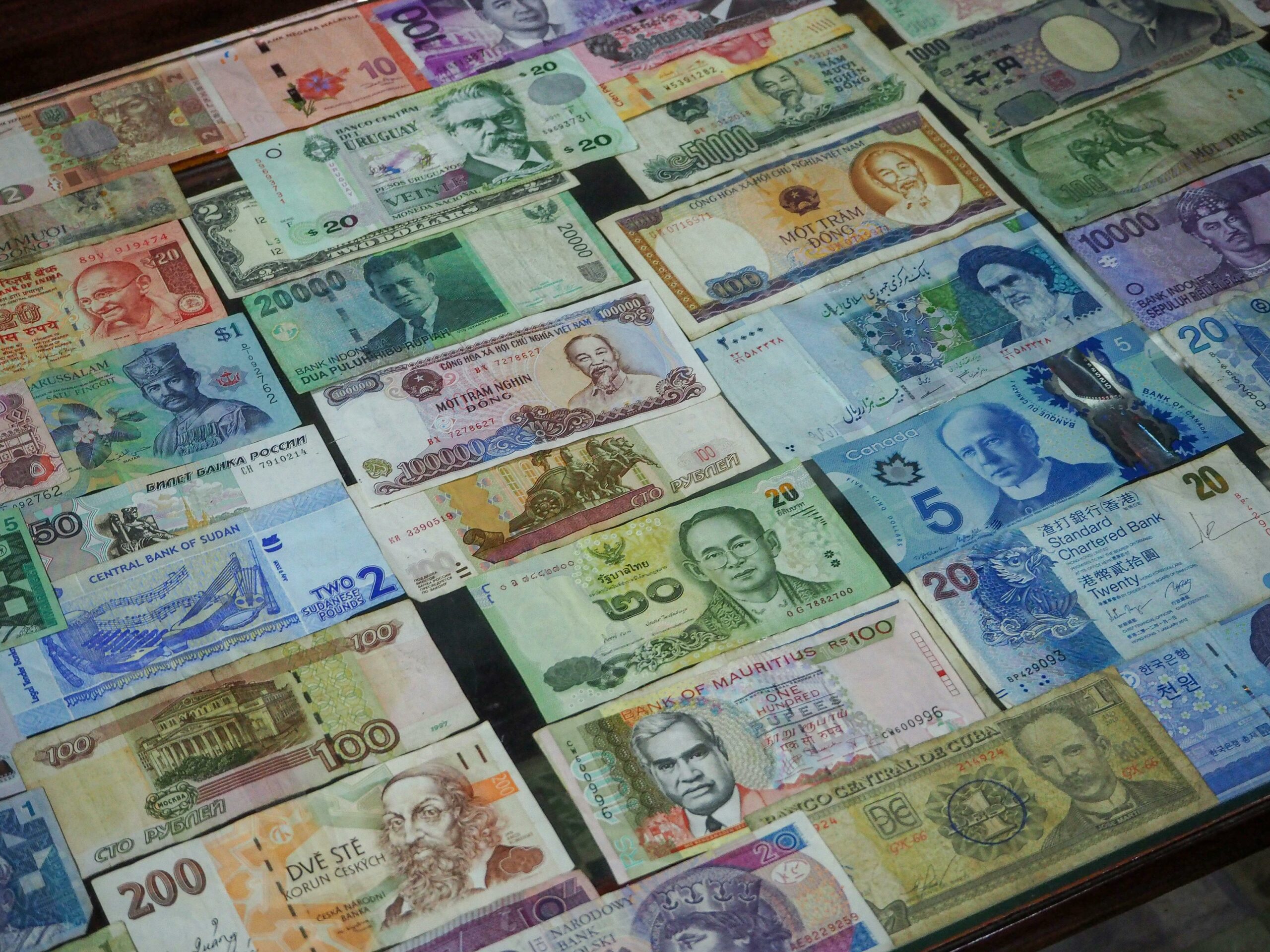 A collection of colorful banknotes from various countries around the world.